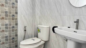 Ein Badezimmer mit Toilette, Waschbecken und Dusche.
