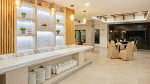 A modern hotel lobby with a marble reception desk, seating area, and a view of the interior. - Superior Twin Retreat | Relaxed Stay for Two (Bangkok)