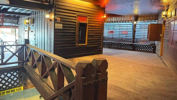 A wooden interior with a staircase, a wooden door, and a view of the outside. - Social Male Dorm | Bed in 8-Bed Friendly Space (Chiang Mai)