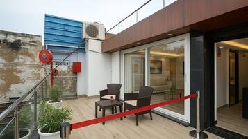 Suite, 1 Bedroom, Balcony, City View | Living area | 32-inch Smart TV with digital channels