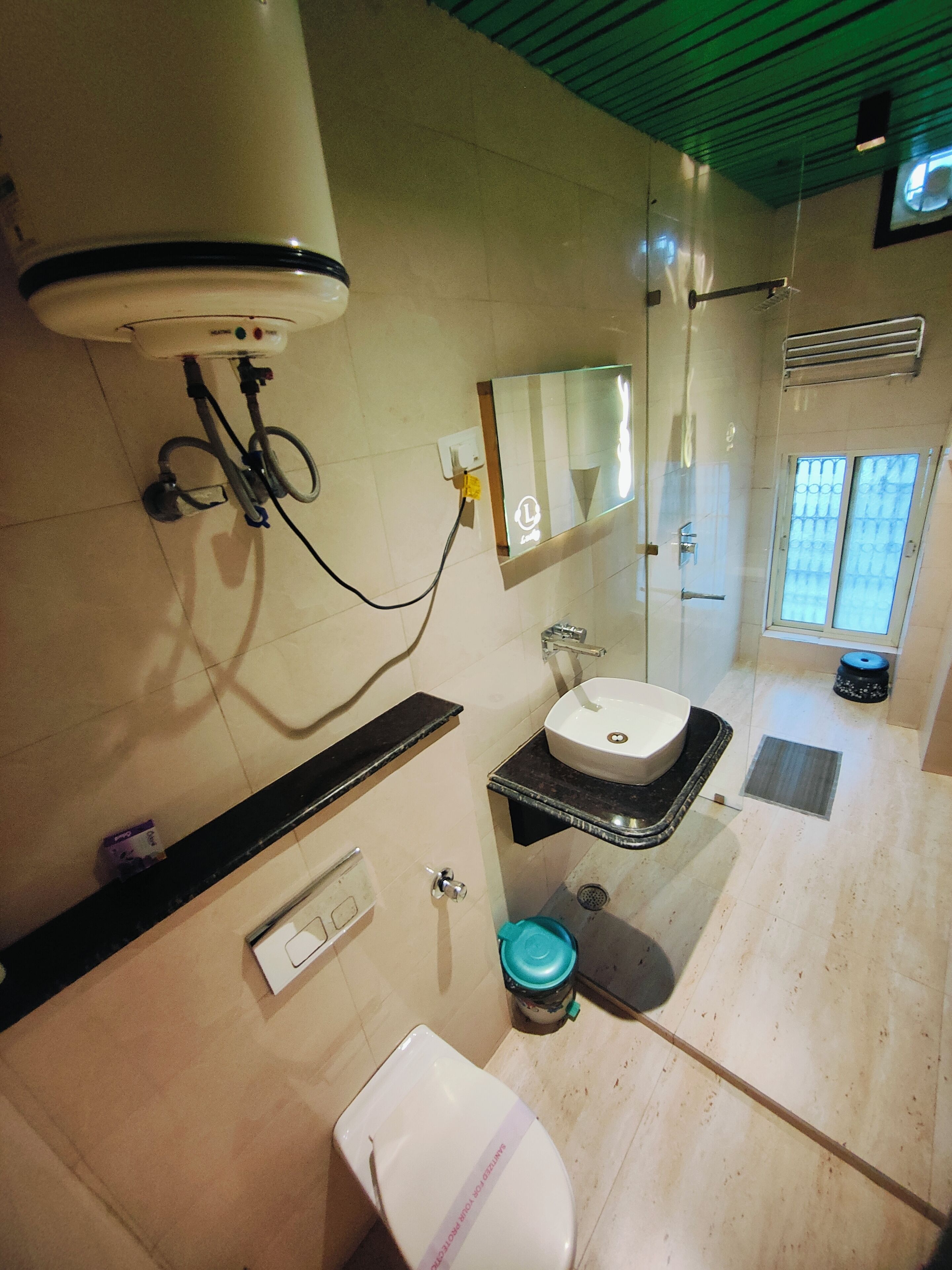 A bathroom with a toilet, sink, and shower.