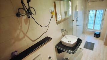 A bathroom with a toilet, sink, and shower.