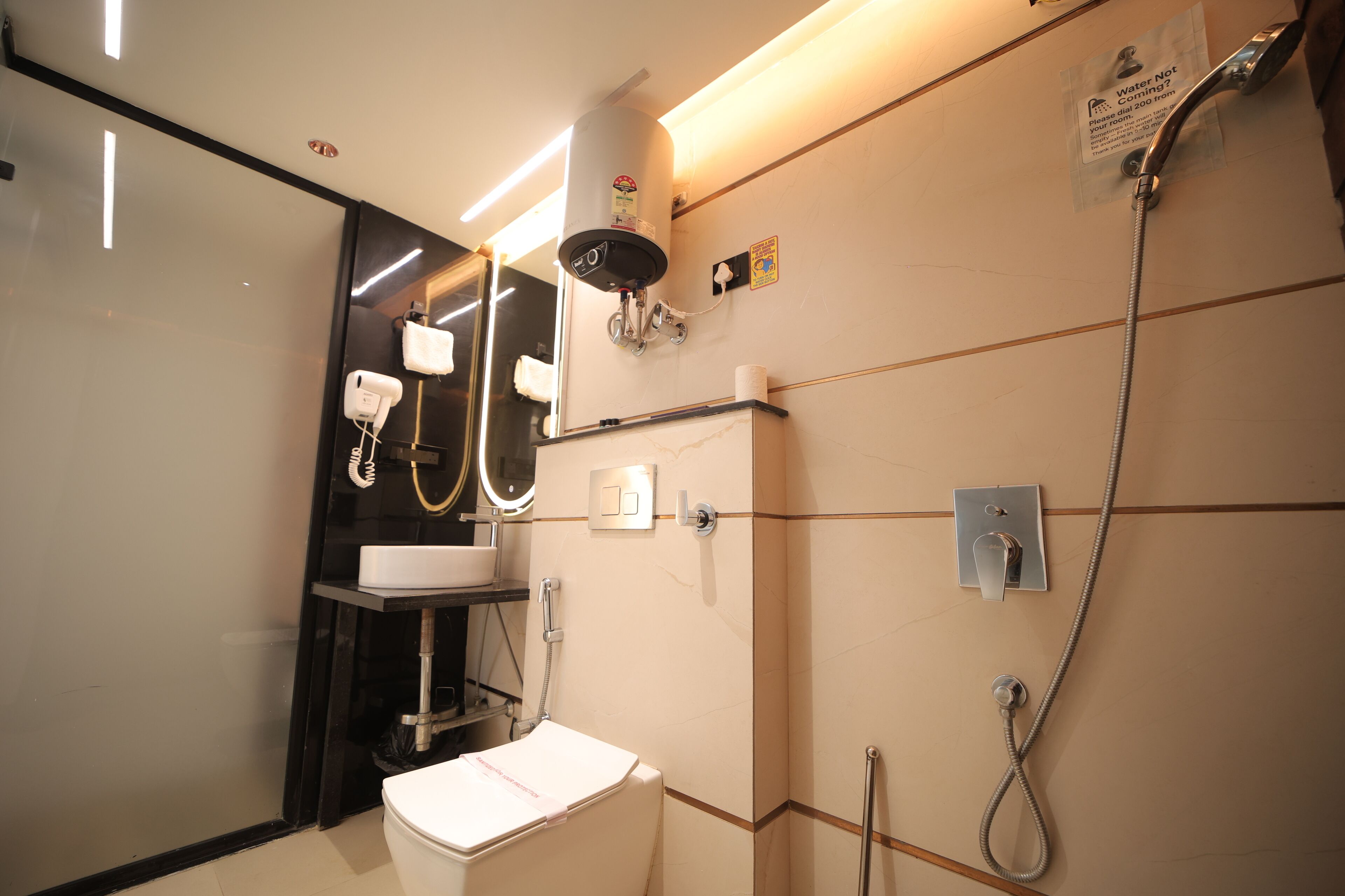 A modern bathroom with a toilet, sink, and shower.
