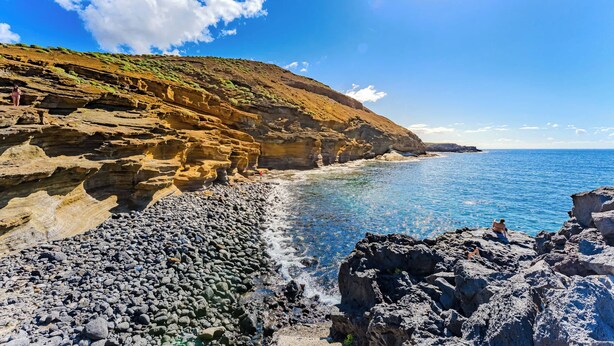A coastal landscape with rocky terrain and clear blue water. - Palmera Sky Terrace Suite (Costa del Silencio)
