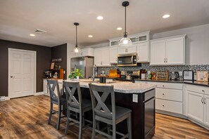 Cook up gourmet meals in the fully equipped chef's kitchen. - Sleeps 18 Luxury 8BR Cabin Hot Tub, Sauna & Game Room (Blakeslee)