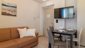 Apartamento família, vista para o mar | Área de estar