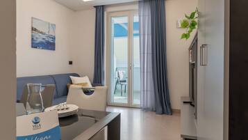 Premium Apartment, Sea View | Living area | 32-inch Smart TV with satellite channels, heated floors
