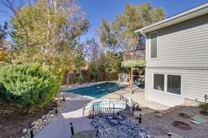 A backyard with a swimming pool, a wooden deck, and a house. - 6 Mi to Barr Lake: Apt w/ Yard & Pool Access! (Brighton)