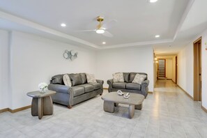 A spacious living room with two grey sofas, a coffee table, and a side table. - 6 Mi to Barr Lake: Apt w/ Yard & Pool Access! (Brighton)