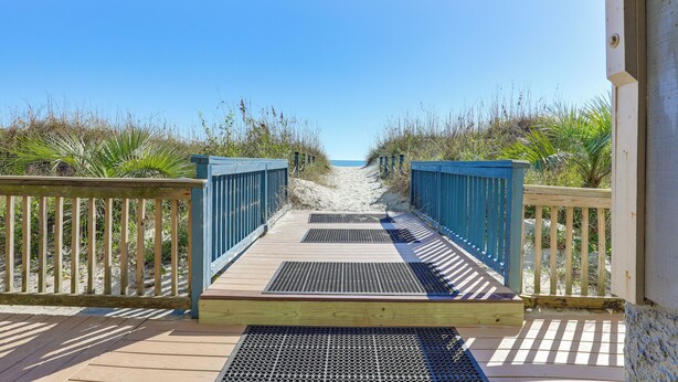 A wooden boardwalk leading to a beach with a clear sky. - Steps to Sea! 3rd-floor Myrtle Beach Condo w/ Pool (Myrtle Beach)
