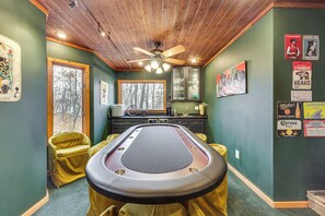 A pool table in a room with green walls, wooden ceiling, and a window overlooking trees. - Grand Wintergreen Resort Home w/ Hot Tub! (Nellysford)