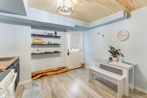 A kitchen with wooden shelves, a white bench, and a clock on the wall. - 12 Mi to Beach! Cozy Cove w/ Patio in Newport (Newport)