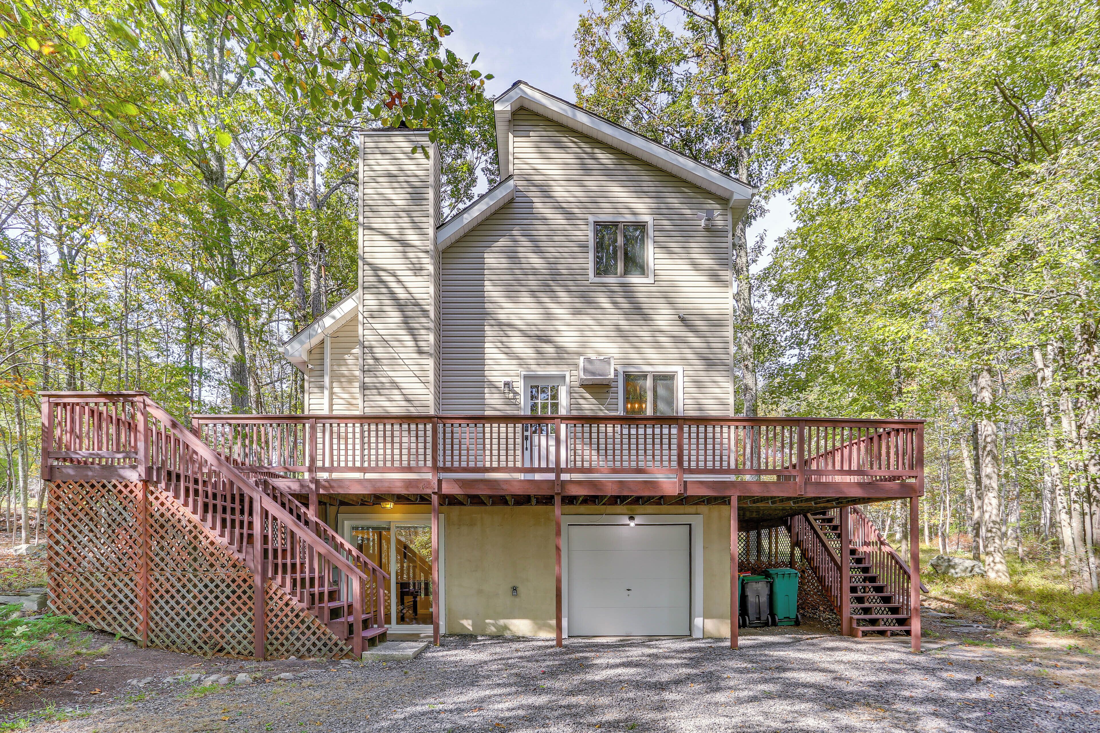 A two-story house with a covered porch, a garage, and a staircase leading to the upper level.