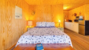 A wooden room with a bed, a desk, and a kitchenette. - Hike, Ski & Golf: Water-view Lake Winola Retreat! (Lake Winola)