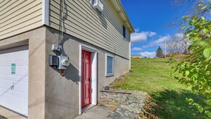 A two-story house with a red door, a garage, and a stone pathway leading to the entrance. - Hike, Ski & Golf: Water-view Lake Winola Retreat! (Lake Winola)