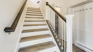A staircase with wooden steps and white railings.