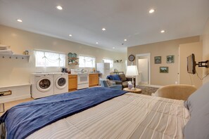 A bedroom with a bed, a washing machine, a sofa, and a small kitchenette. - Cozy Couple's Retreat 5 Mi to Garden of the Gods! (Colorado Springs)