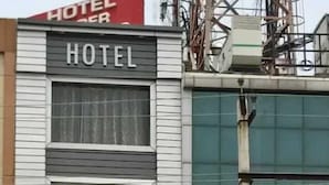 A hotel named 'Hotel Kuber 7' with a modern facade, large windows, and a visible entrance. - Hotel Kuber 7 (Zirakpur)