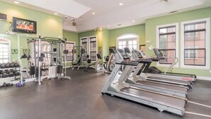 A gym with treadmills, weight machines, and dumbbells. - Landing Apartments New Haven (New Haven)