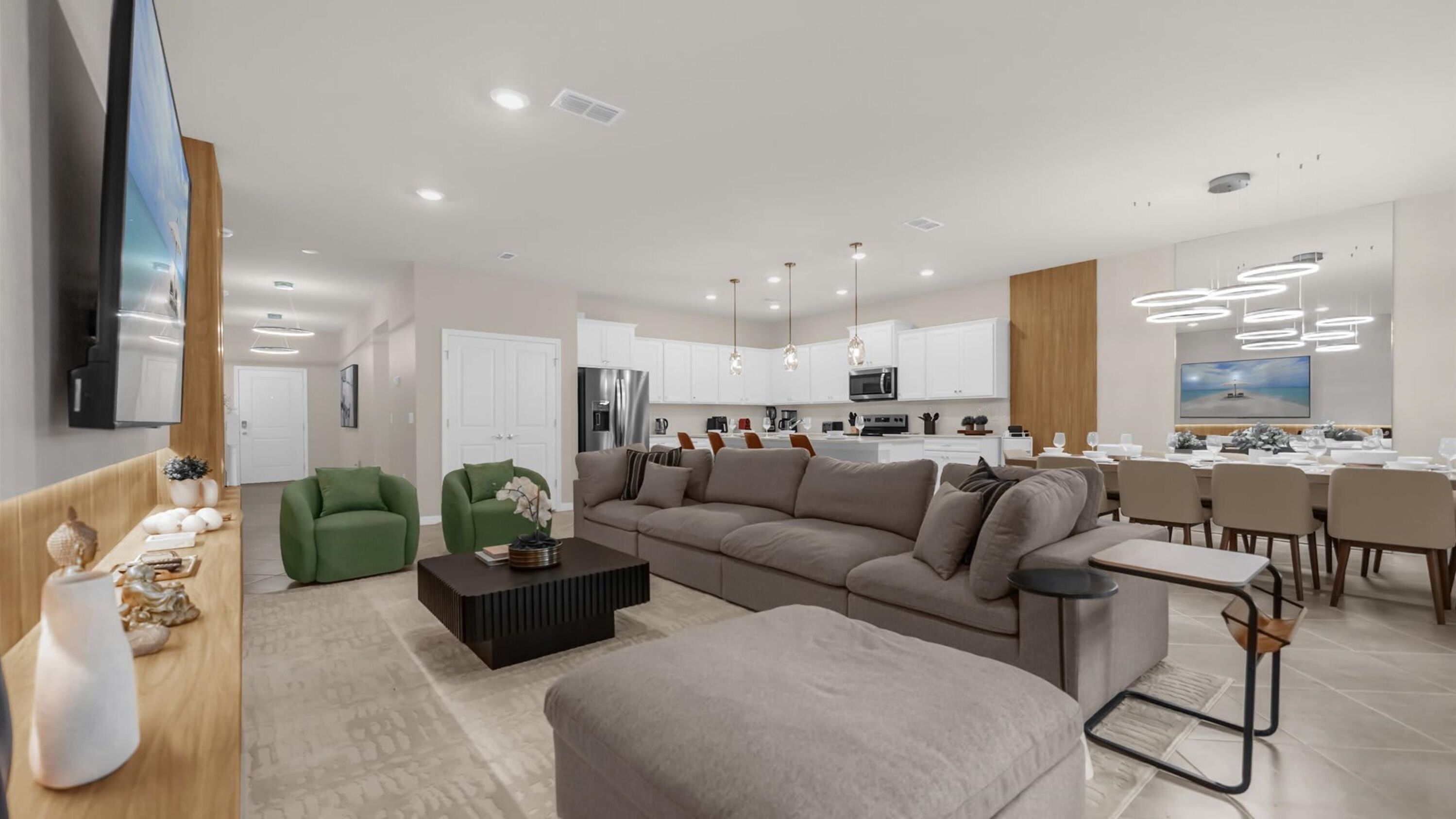 A modern living room with a sofa, green armchairs, and a coffee table.