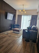 Basic Apartment, 2 Bedrooms, Balcony, City View | Living room | 50-inch LED TV with cable channels