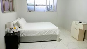 A neatly arranged bedroom with a bed, a nightstand, a desk, and a cabinet. - Casa Estancia Jaén * Jaén Country House *. (Jaén)