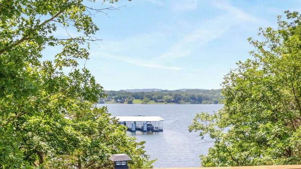 A hot tub on a deck with a view of a lake and a dock. - Table Rock Lake Cabin - The Oaks #5 with Lake Access & Hot Tub (Shell Knob)