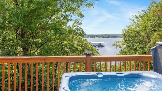 A hot tub on a wooden deck with a view of a lake and dock. - Table Rock Lake Cabin - The Cedars #1 with Lake Access, Hot Tub, Outdoor Pool (Shell Knob)