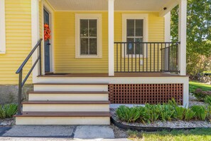 A yellow house with a front porch, steps, and a small garden. - Pepperrell Place - Home for 6 (Kittery)