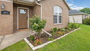 A brick house with a front door, a mailbox, and a number 804 sign. - The Bentonville Basecamp (Bentonville)