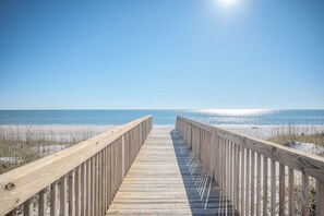 A wooden boardwalk leading to a beach with clear skies. - Sunset Haven: Beautiful, Caswell Beach, Oceanfront Condo (Caswell Beach)