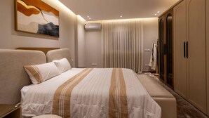 A modern bedroom with a large bed, a wardrobe, and an air conditioning unit. - 3-bedroom apartment in enchanting Cairo Governorate with AC (Cairo Governorate)