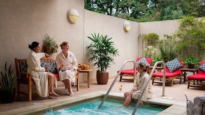 A poolside area with lounge chairs and a pool. - Luxe Golf View Condo | Prime Napa Location (Napa)