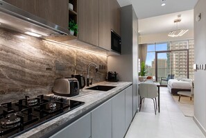 Fridge, microwave, stovetop, coffee/tea maker - Stylish Comfort Studio in Westwood Grande (Jumeirah Village Circle (JVC))