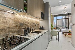 Fridge, microwave, stovetop, coffee/tea maker - Chic & Sleek Studio in Westwood Grande (Jumeirah Village Circle (JVC))