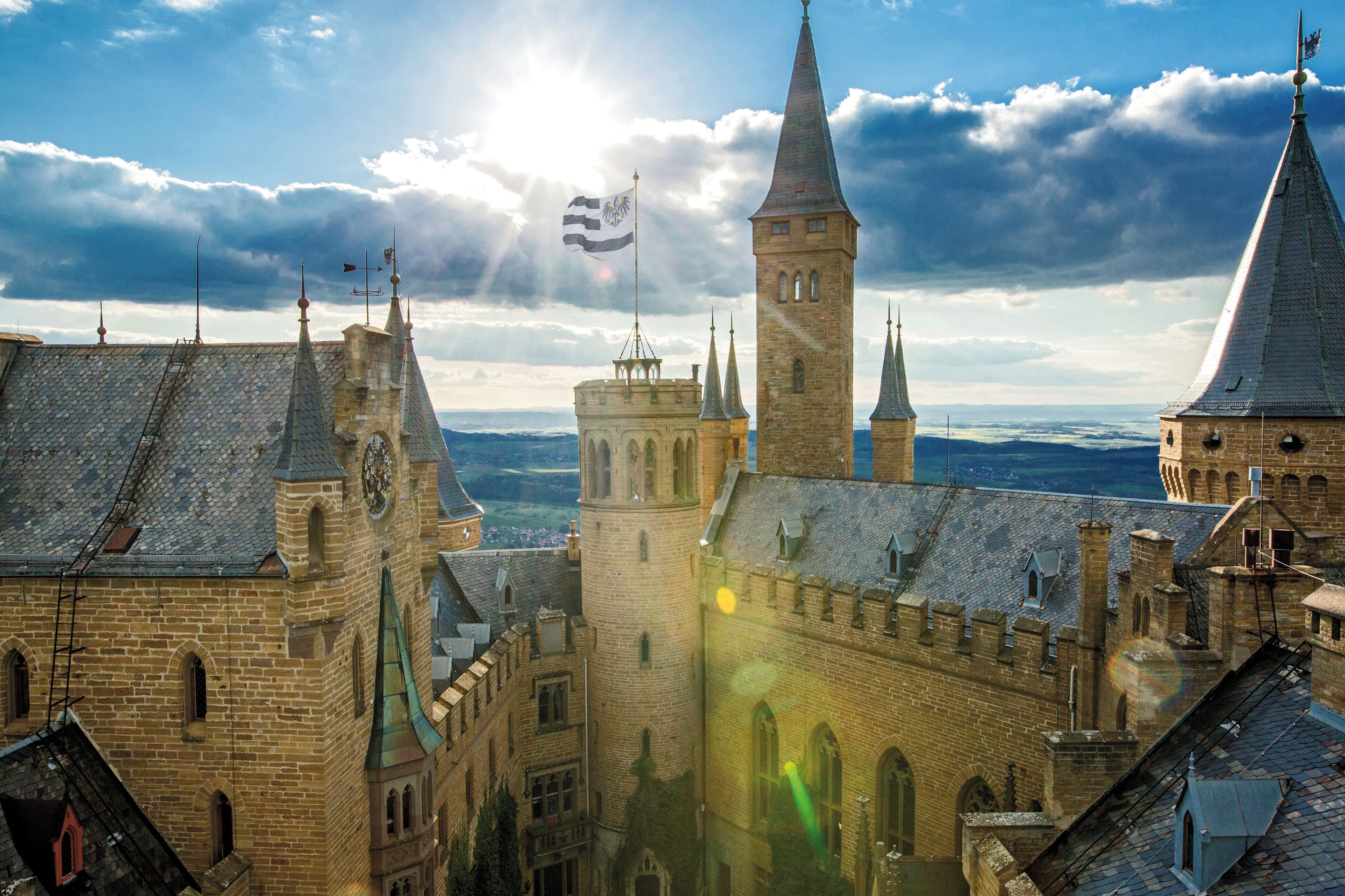 A historic building with multiple towers and a prominent clock tower.