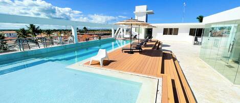 Outdoor pool, open 7:00 AM to 7:00 PM, pool umbrellas, pool loungers