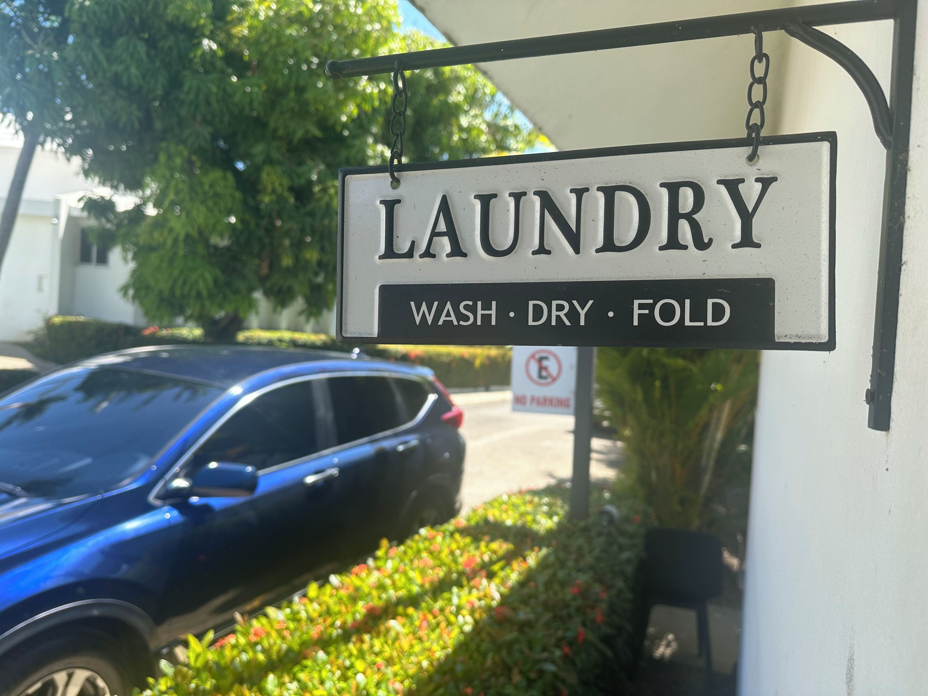 A laundry sign with 'WASH DRY FOLD' instructions.