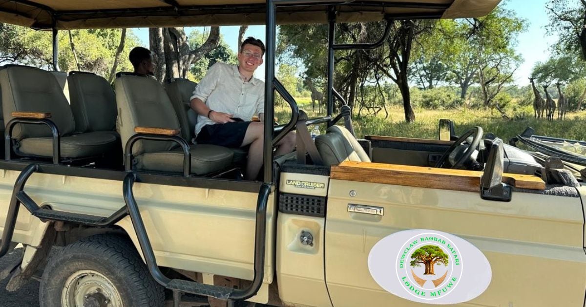 A safari vehicle with a logo for 'Dircala Baobar Lodge' and 'Lodge Mfweye' on the side.