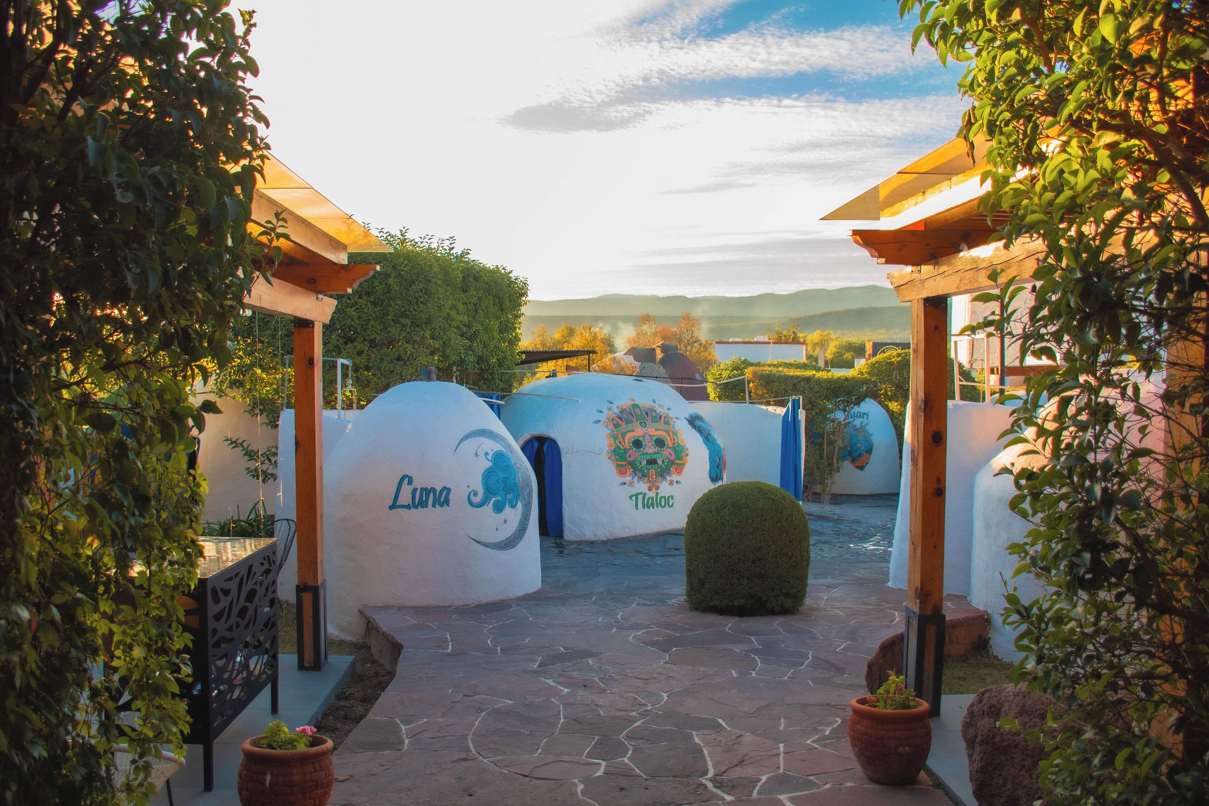 A pathway leading to a building with spherical structures labeled "Luna" and "Taloc".