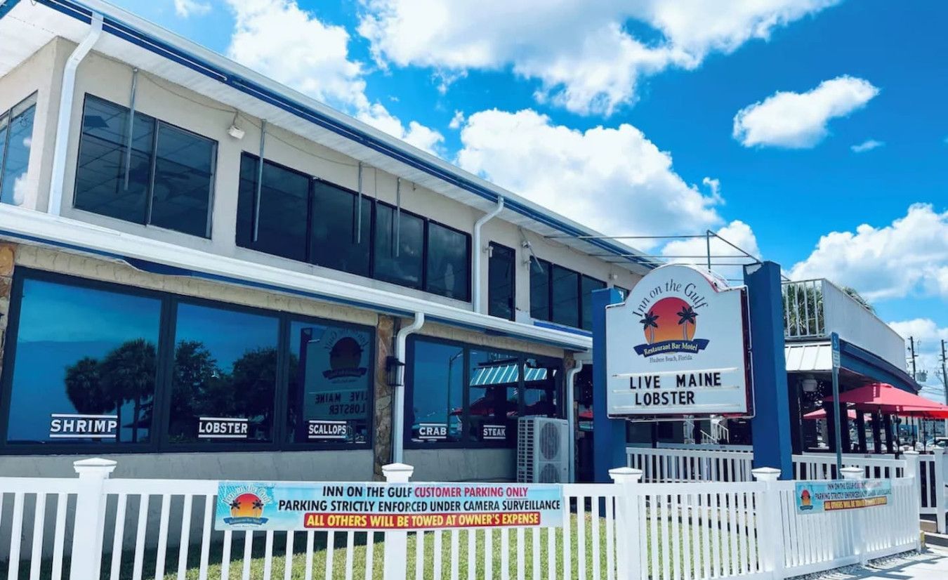 A restaurant with a sign indicating it serves live Maine lobster.