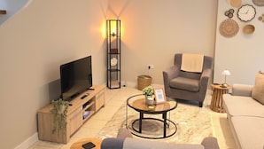 A modern living room with a TV, sofa, armchair, and coffee table. - School Path in the heart of the historic Ironbridge (Telford)
