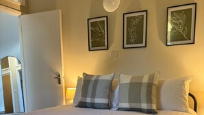 A neatly made bed with white linens, two pillows, and rolled towels. - School Path in the heart of the historic Ironbridge (Telford)
