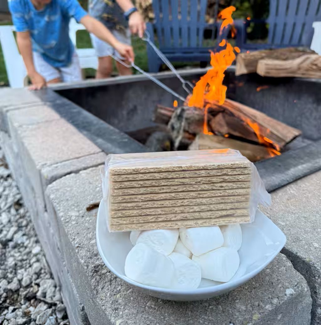 A campfire with logs and a stack of wood.