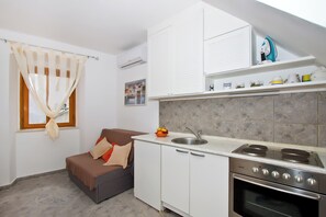 Apartment, 1 Queen Bed with Sofa bed | Private kitchen | Full-size fridge, stovetop, cookware/dishes/utensils