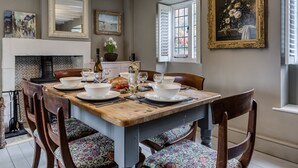 A dining room with a wooden table set for four, surrounded by upholstered chairs. - Archway House - Blockley, Moreton-in-Marsh (Blockley)