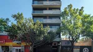 A multi-story building with balconies, a mural, and a tree in front. - Centric 2 BR Condo in the Heart Roma Norte (Mexico City)