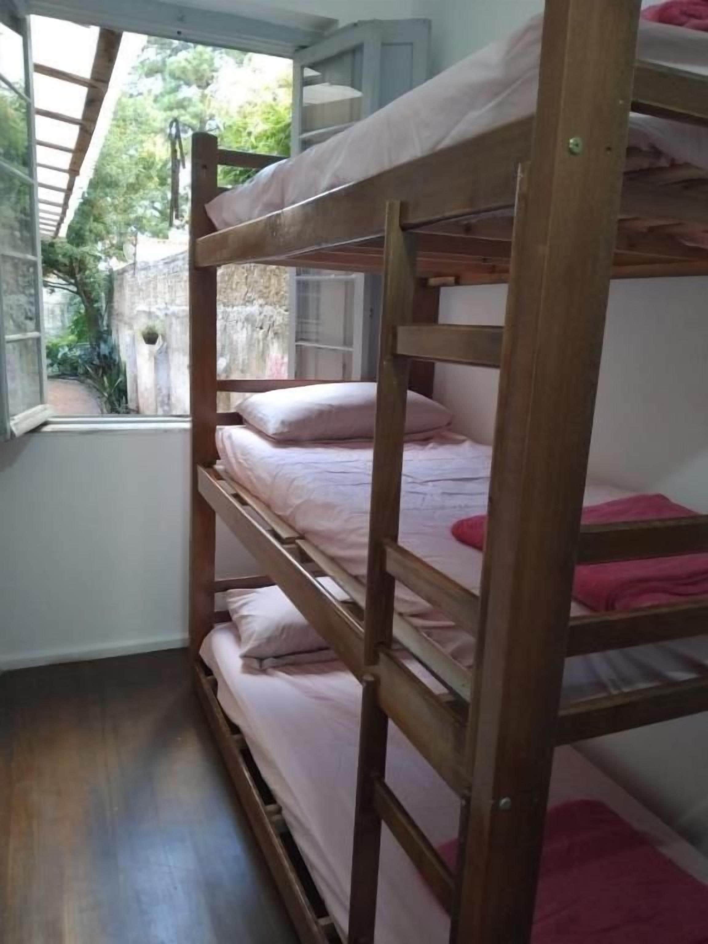 A bunk bed with a window view.