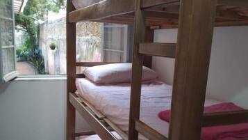 A bunk bed with a window view.