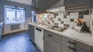A kitchen with a dishwasher, a sink, and a tiled backsplash. - 3 bedroom cozy apartment in Finspång (Finspång)